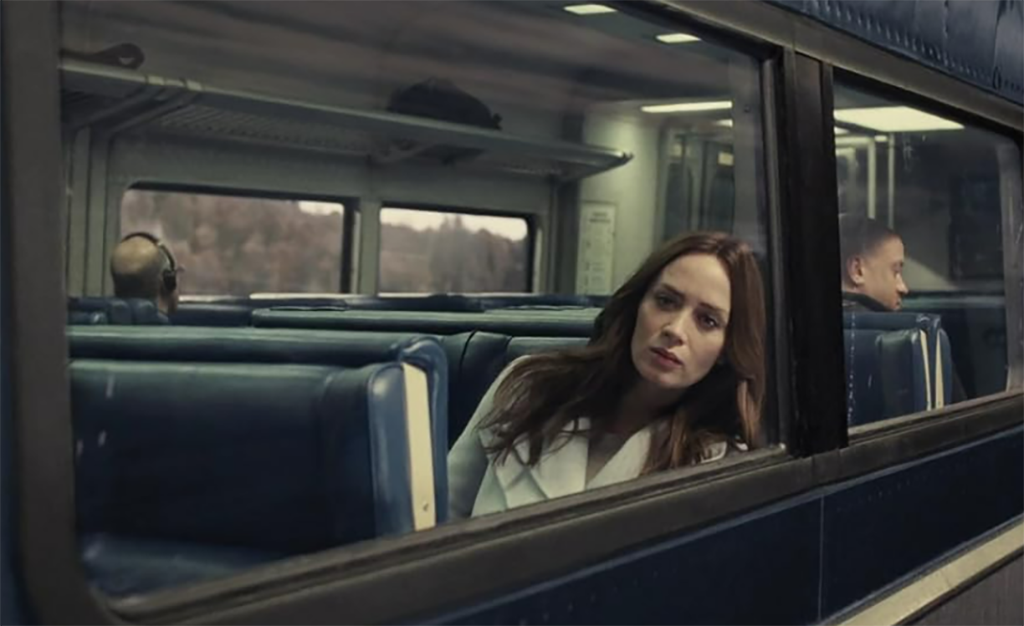 ACtor Emily Blunt, on a Metro-North train car, looks out of the window 