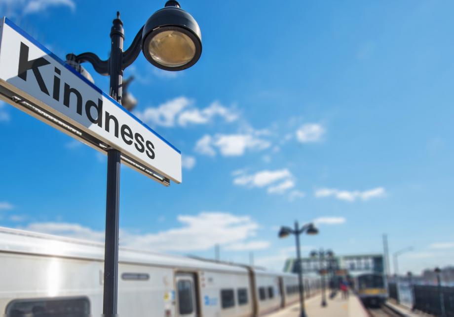 A rendering shows a Long Island Rail Road-style sign with the word "Kindness" on it