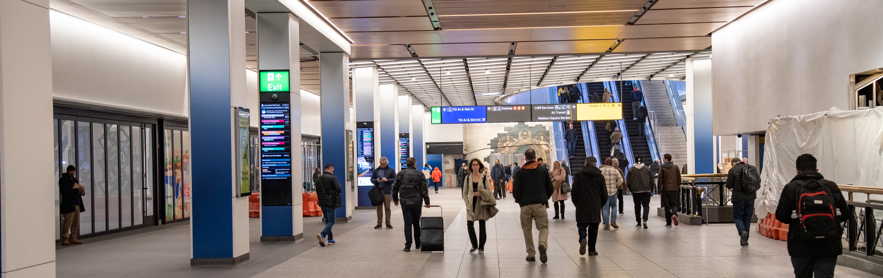People walk through the renovated concourse at Penn Station