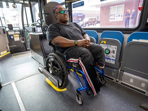A customer with a mobility device whose device has been secured by the Quantum self-securement system.