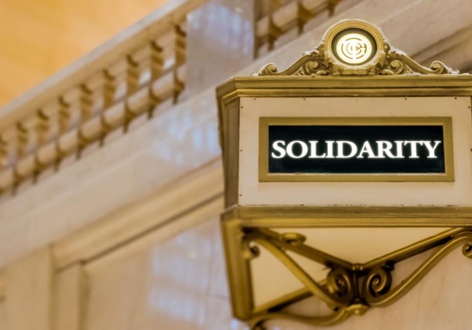A rendering shows a Grand Central-style sign with the word "Solidarity" on it