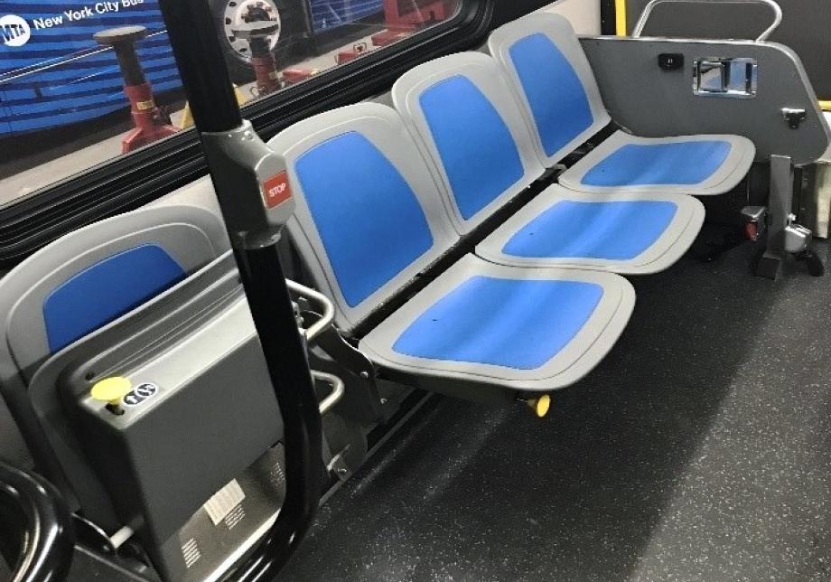 A bench of three seats flipped down next to a single seat flipped up. 