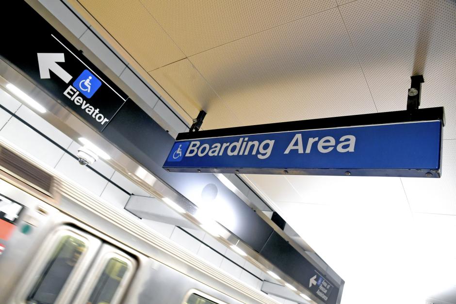 A sign for an accessible boarding area on a subway platform.